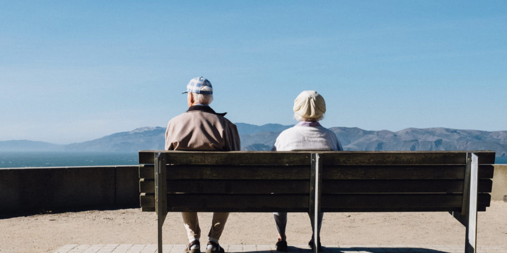 Two people thinking if Parkinson's is fatal. They are on a bench, outside.