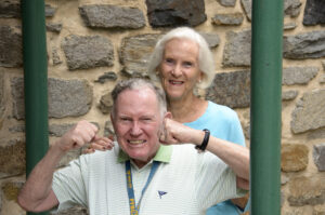 A person with Parkinson's defiantly flexing.